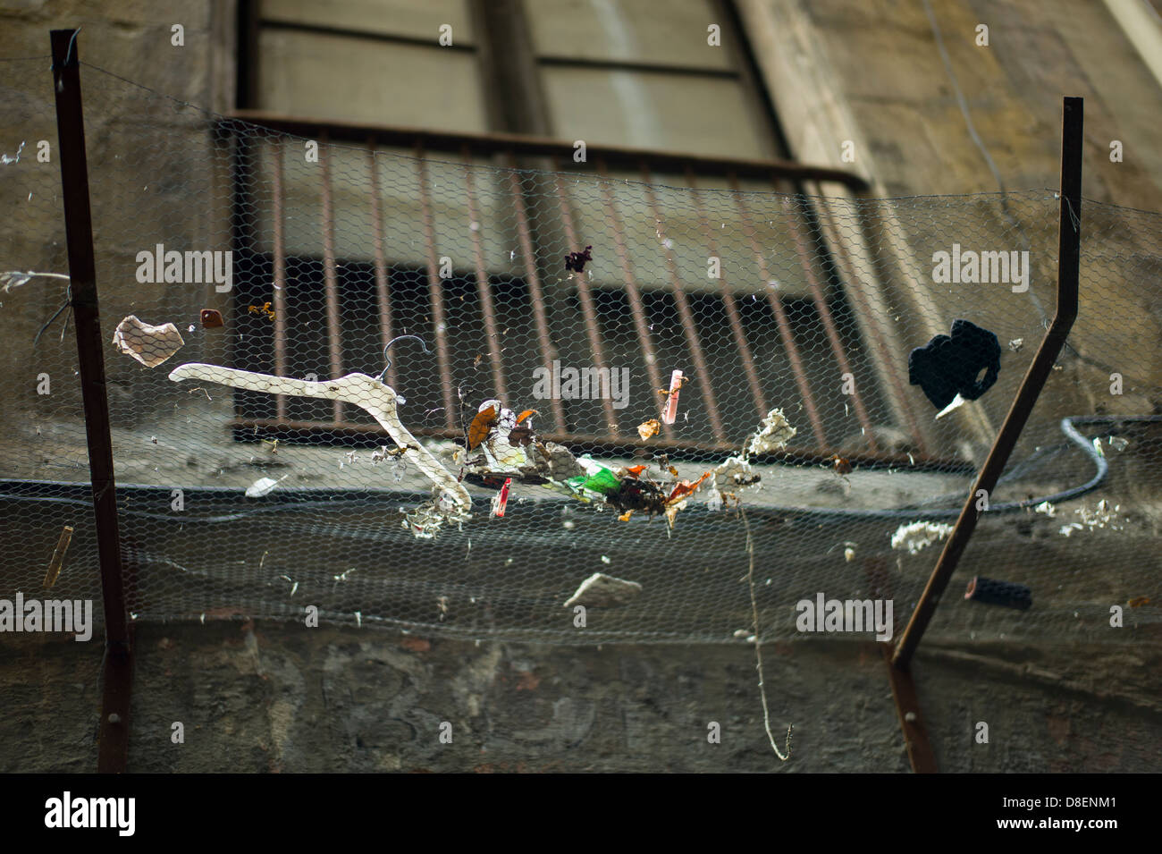 Overhead waste caught in chicken wire Barcelona Spain Stock Photo