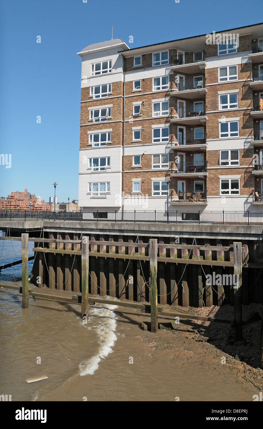 Detail showing new residential property built on the banks of the River Thames using sheet pile to support the river bank. Stock Photo