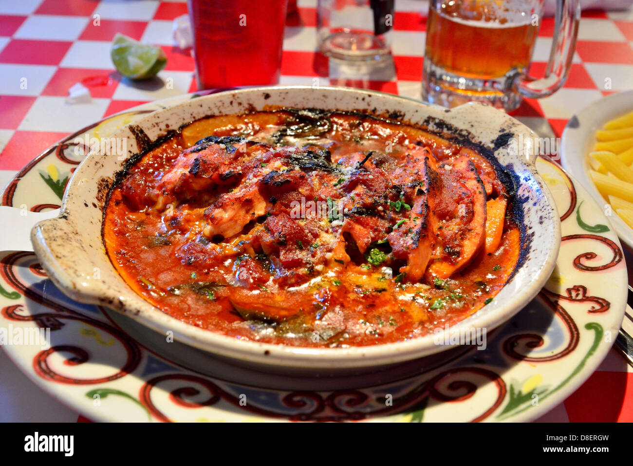 Local cuisine of southwest US, chicken tomato sauce, served in a clay plate. Moab, Utah, USA. Stock Photo