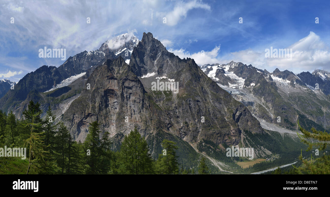 Mountains and pine trees under cloudy blue sky Stock Photo - Alamy