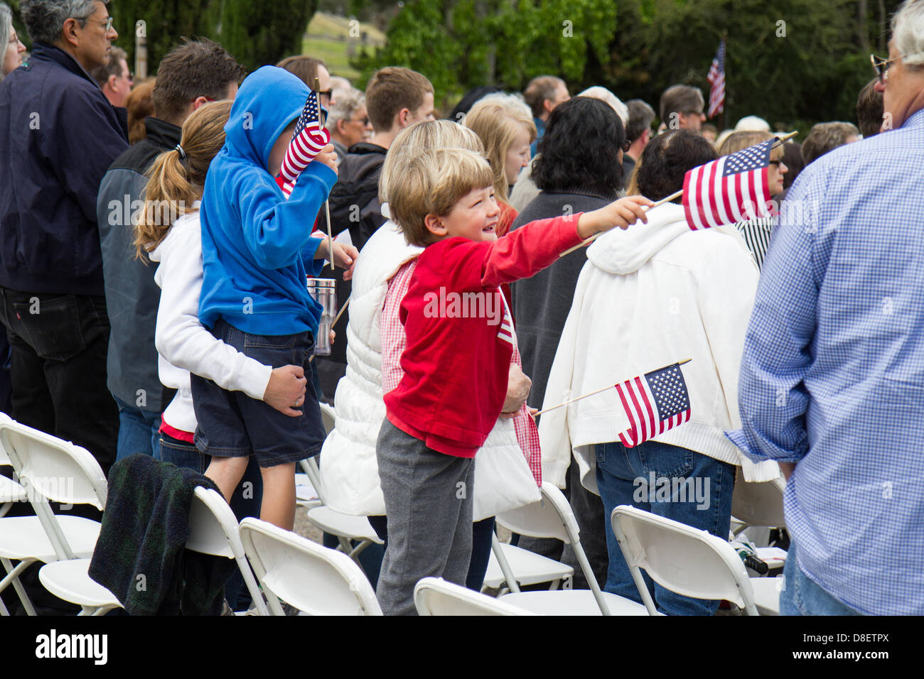 A boy waves an American flag during the 92nd annual Memorial Day ...