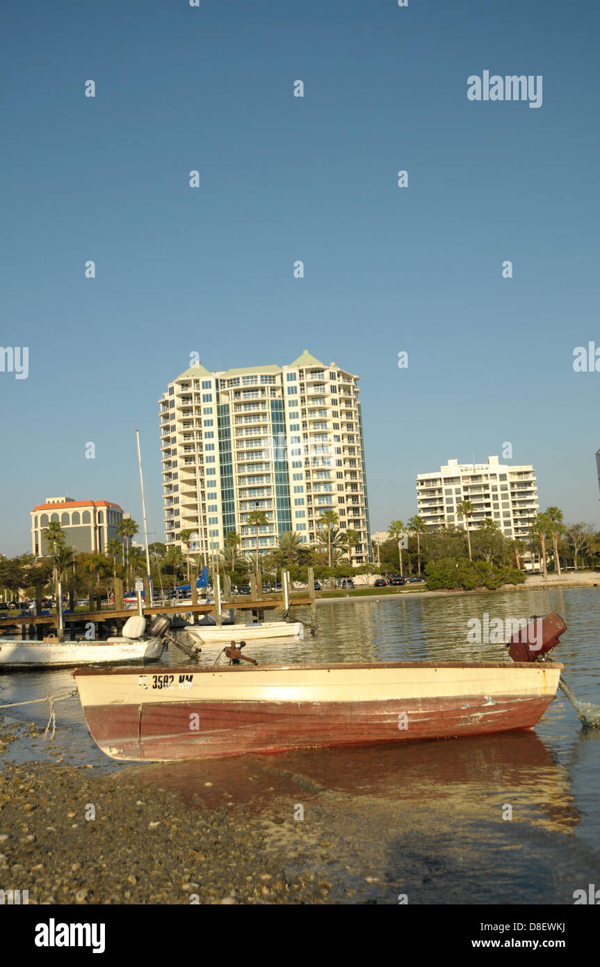 A boat sits in the foreground as high rises sit in the background. Stock Photo