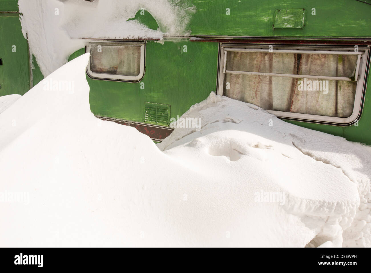 A caravan snowed in by large snow drifts during the extreme weather event of late March 2013, near Ambleside, Stock Photo