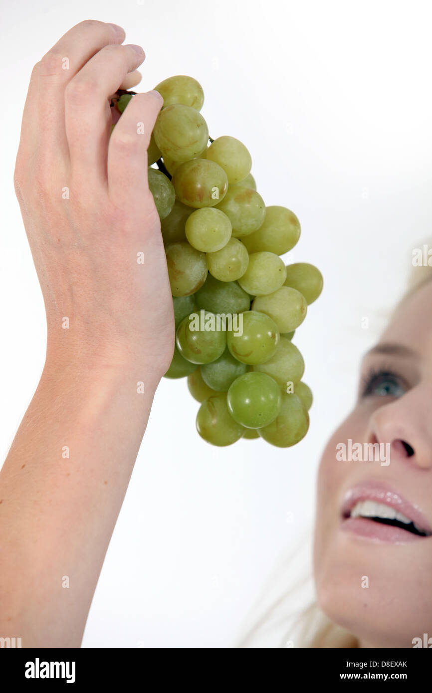 woman eating grapes Stock Photo - Alamy