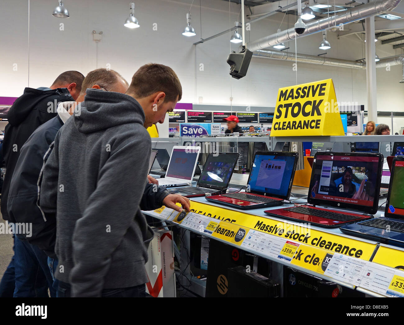 Customers looking at laptops in PC World computer store, UK Stock Photo