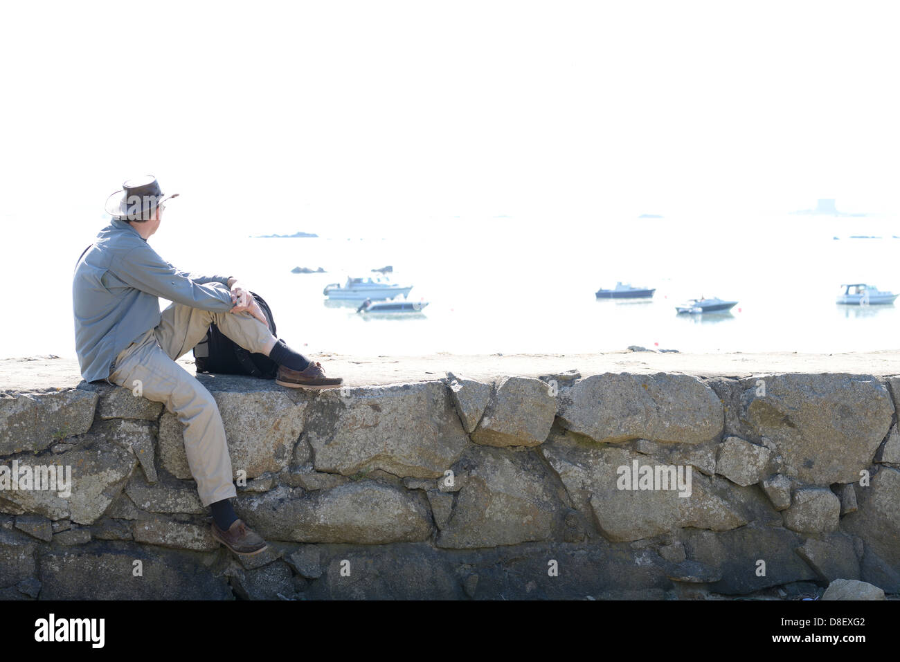 Man in a hat looking out to sea Stock Photo - Alamy
