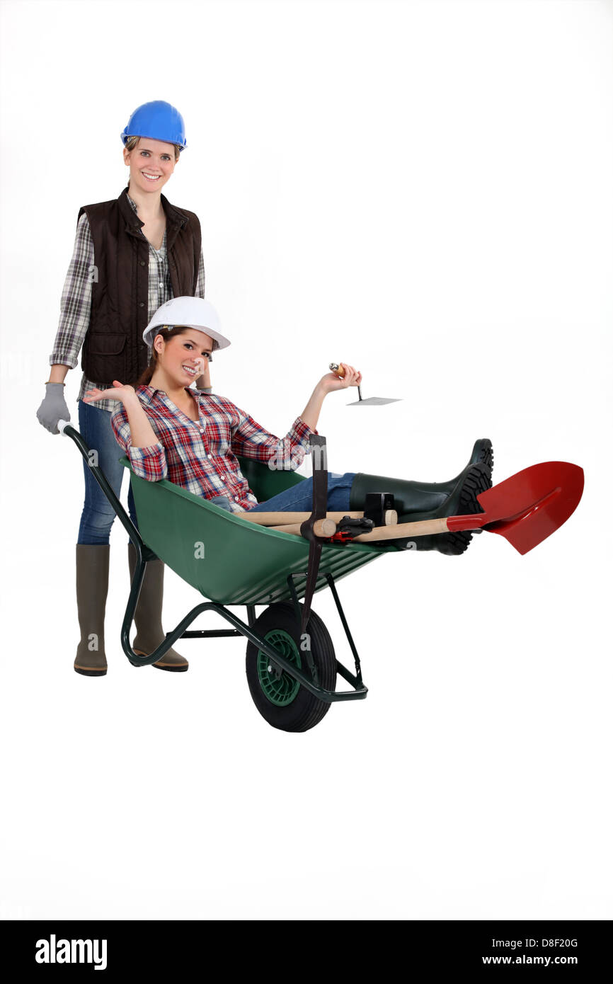 Two women with wheelbarrow Stock Photo - Alamy