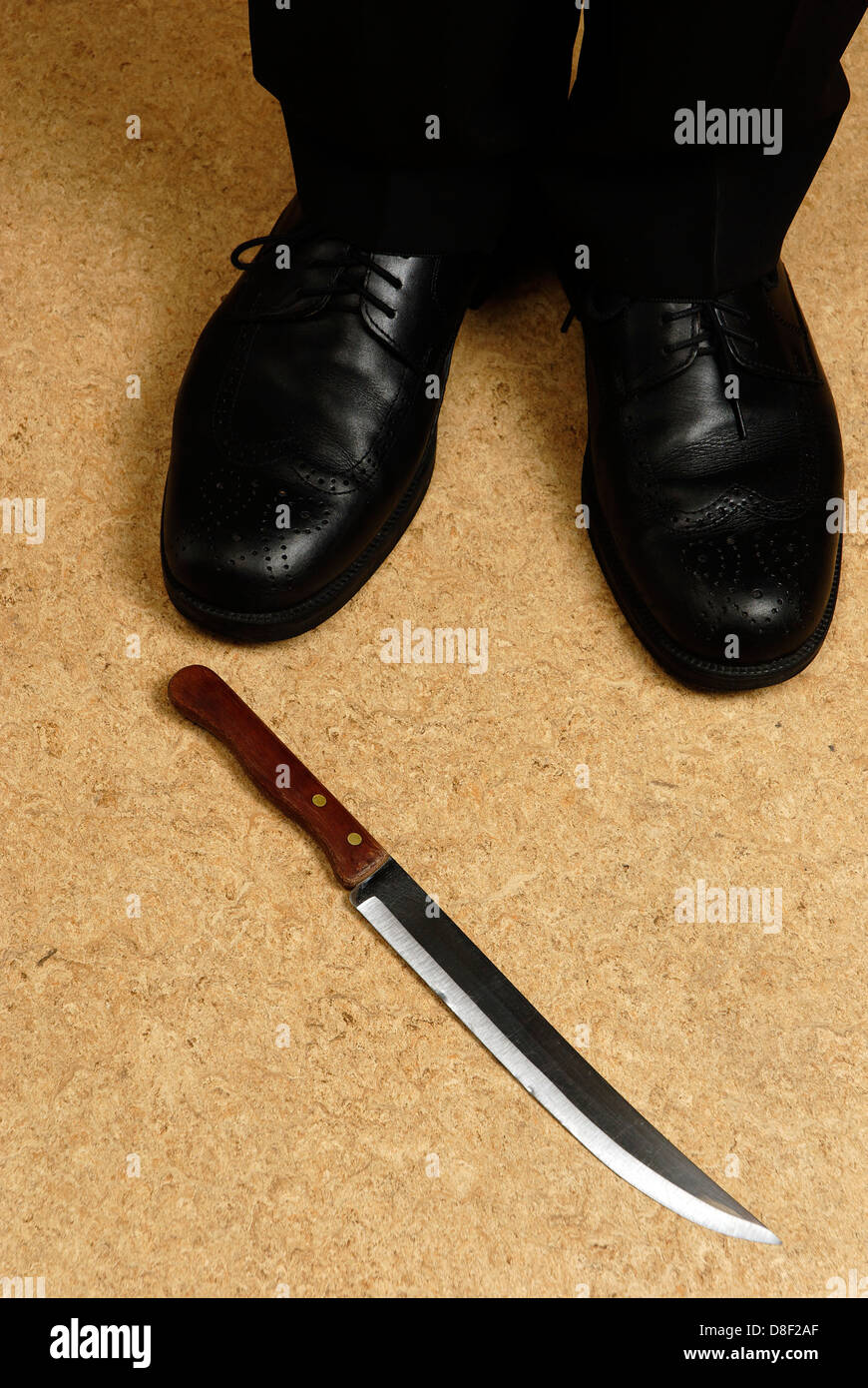 Man standing in front of a knife Stock Photo Alamy