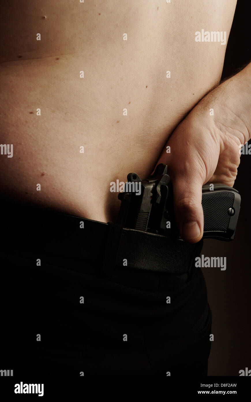 The back of a man with a gun Stock Photo - Alamy