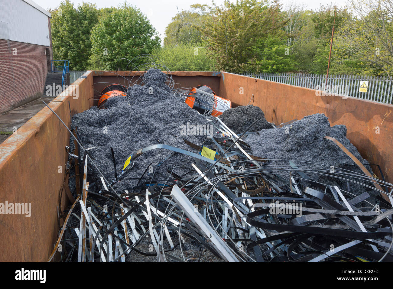 A large container full of scrap metal left over from product