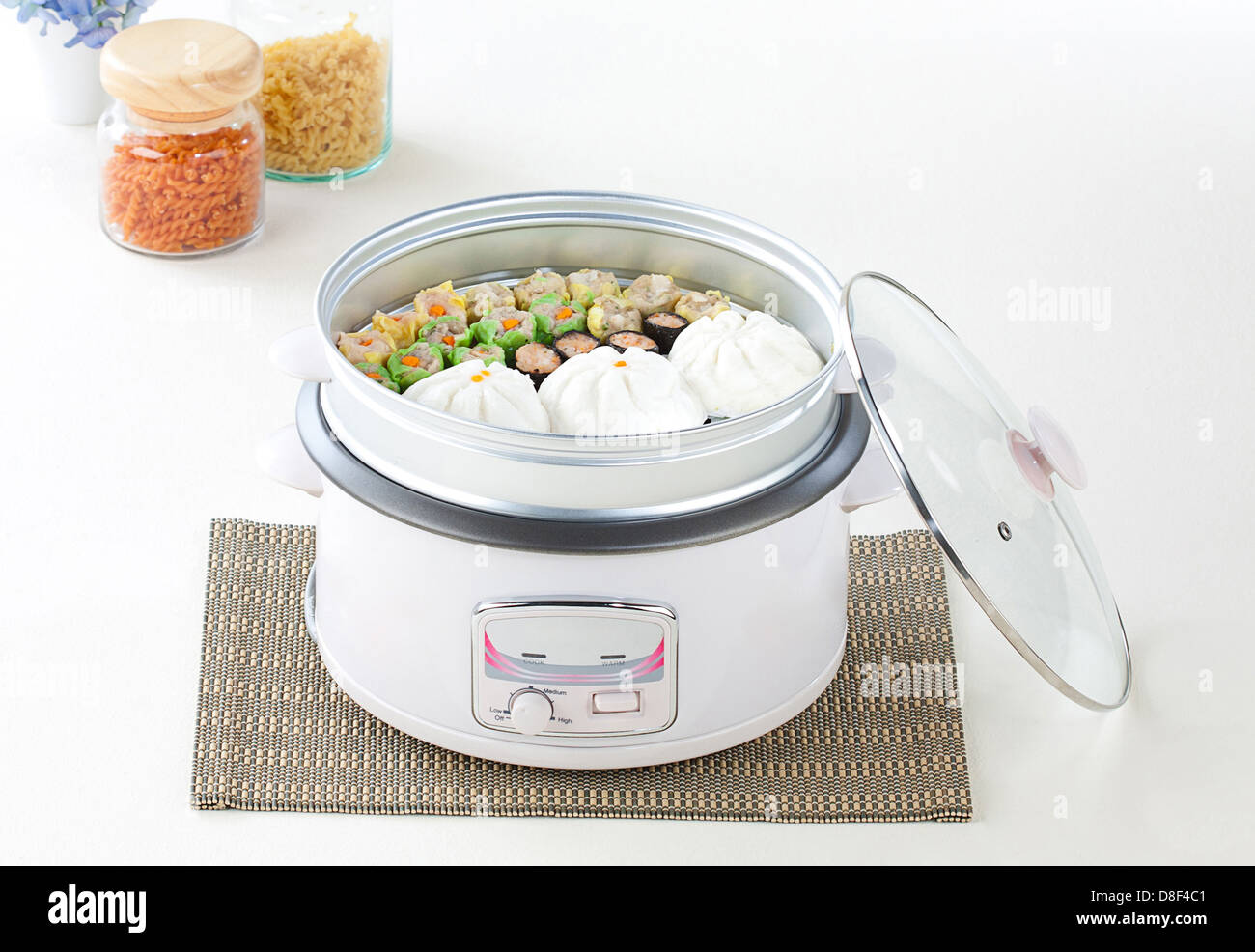 Electric rice cooker and tray for steaming food Stock Photo