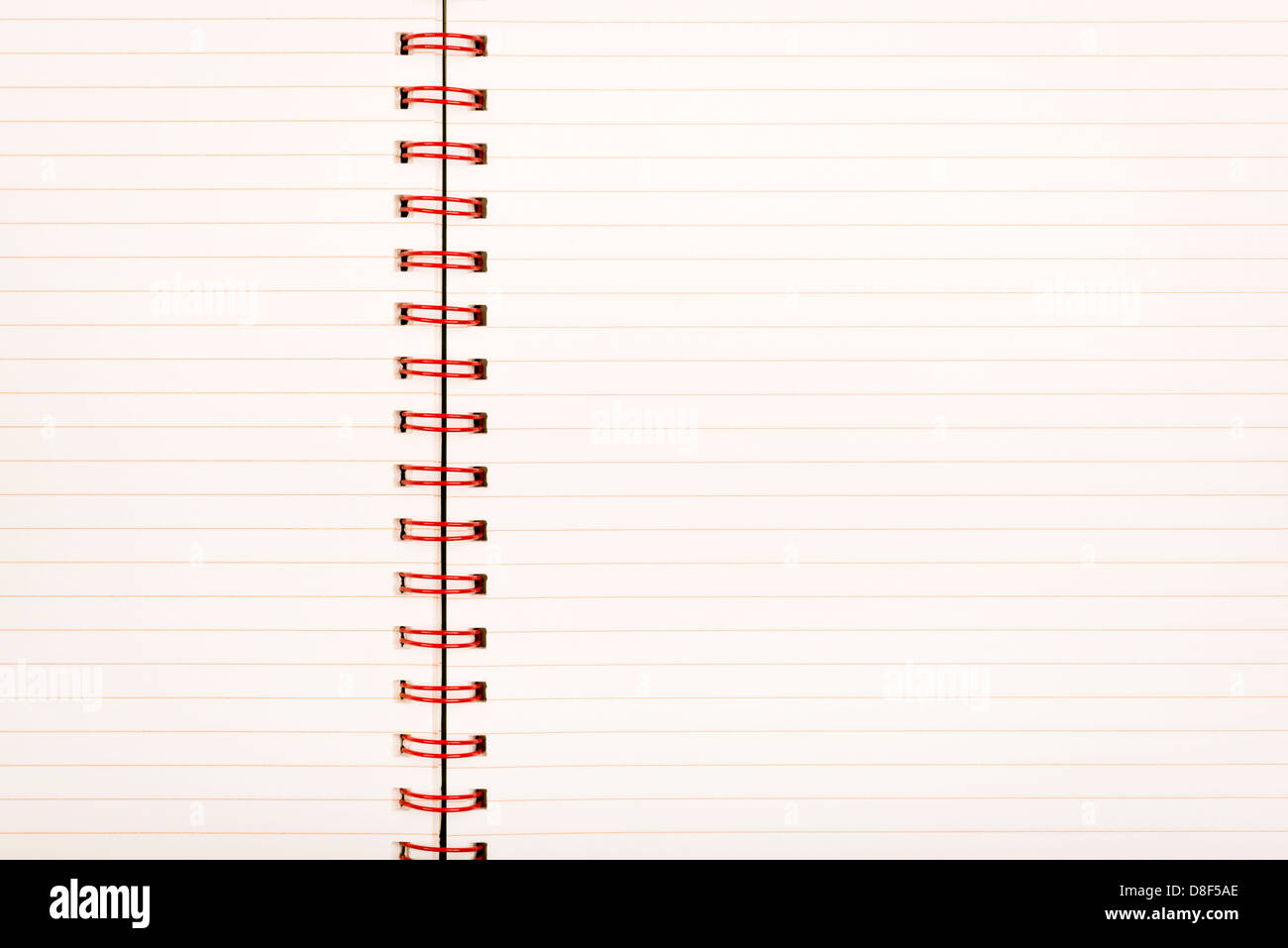 Notebook with pale lined paper and red metal binding as background Stock Photo