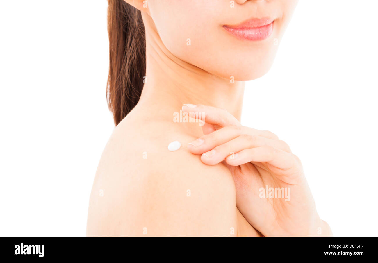 shoulder of young woman applying moisturize cream Stock Photo