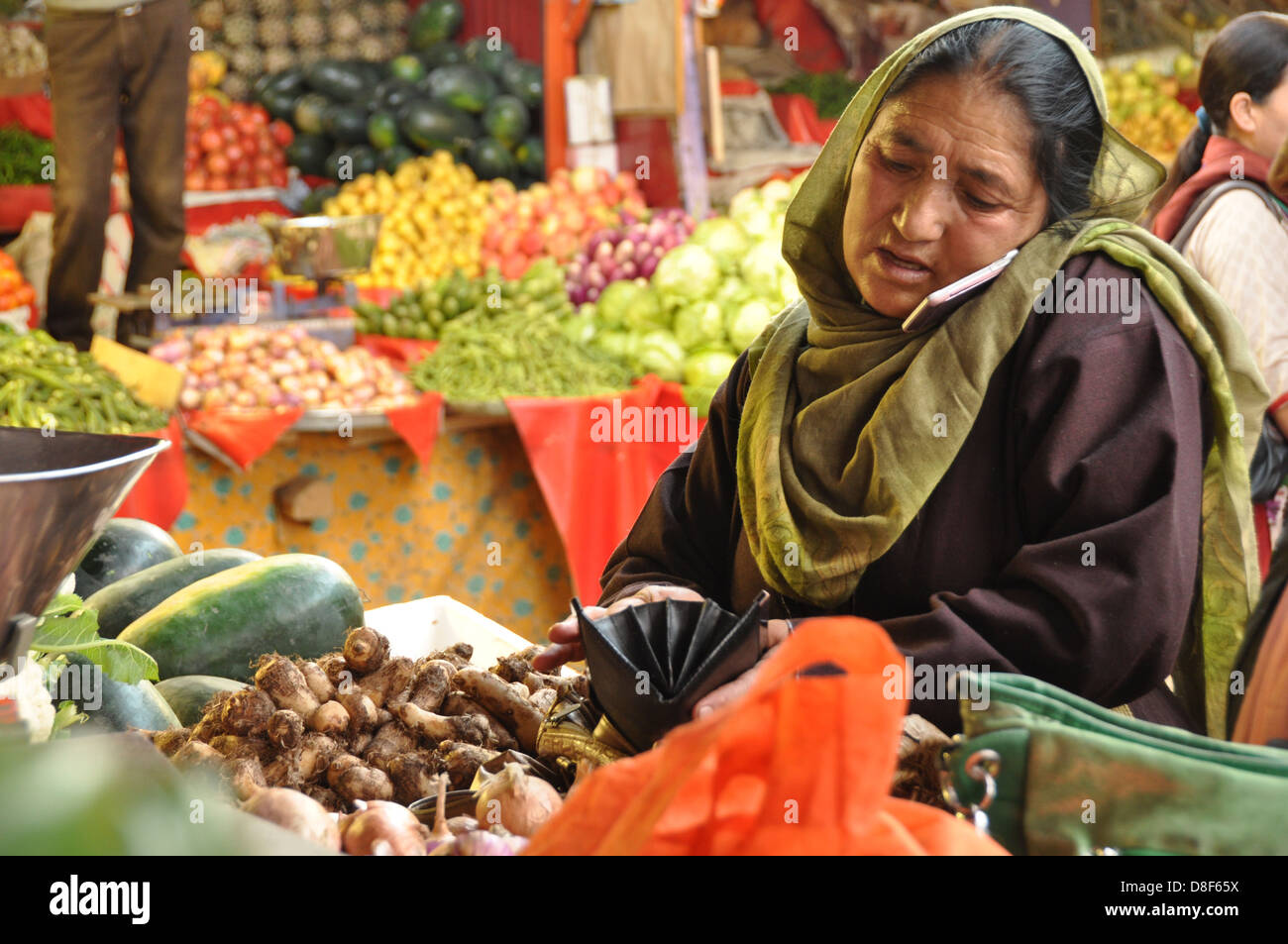Indian woman on her cell phone at the Leh vegetable market, Ladakh