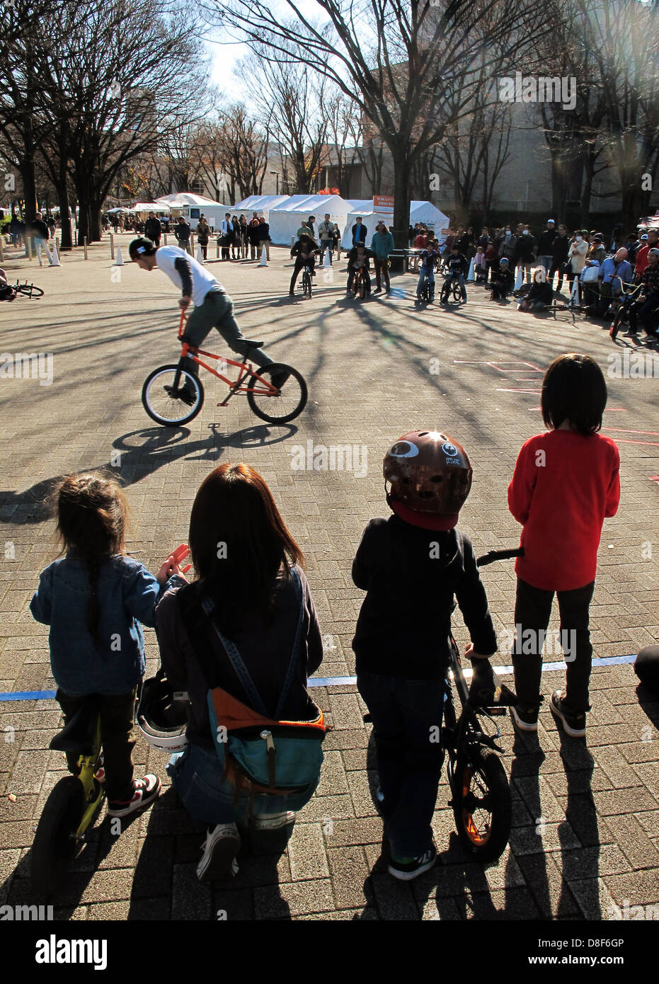 Unidentified children watch unidentified BMX biker show in Yoyogi Park Harajuku, Japan Stock Photo