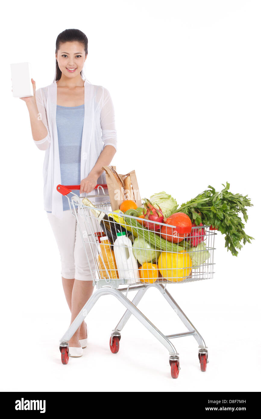 Young woman shopping with shopping cart Stock Photo Alamy