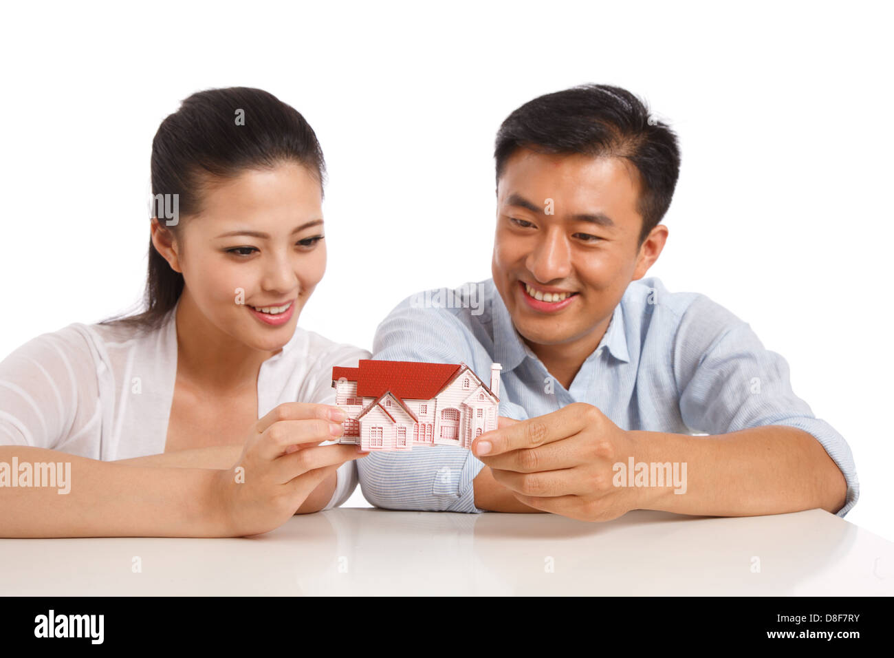 Young couple holding house model Stock Photo - Alamy