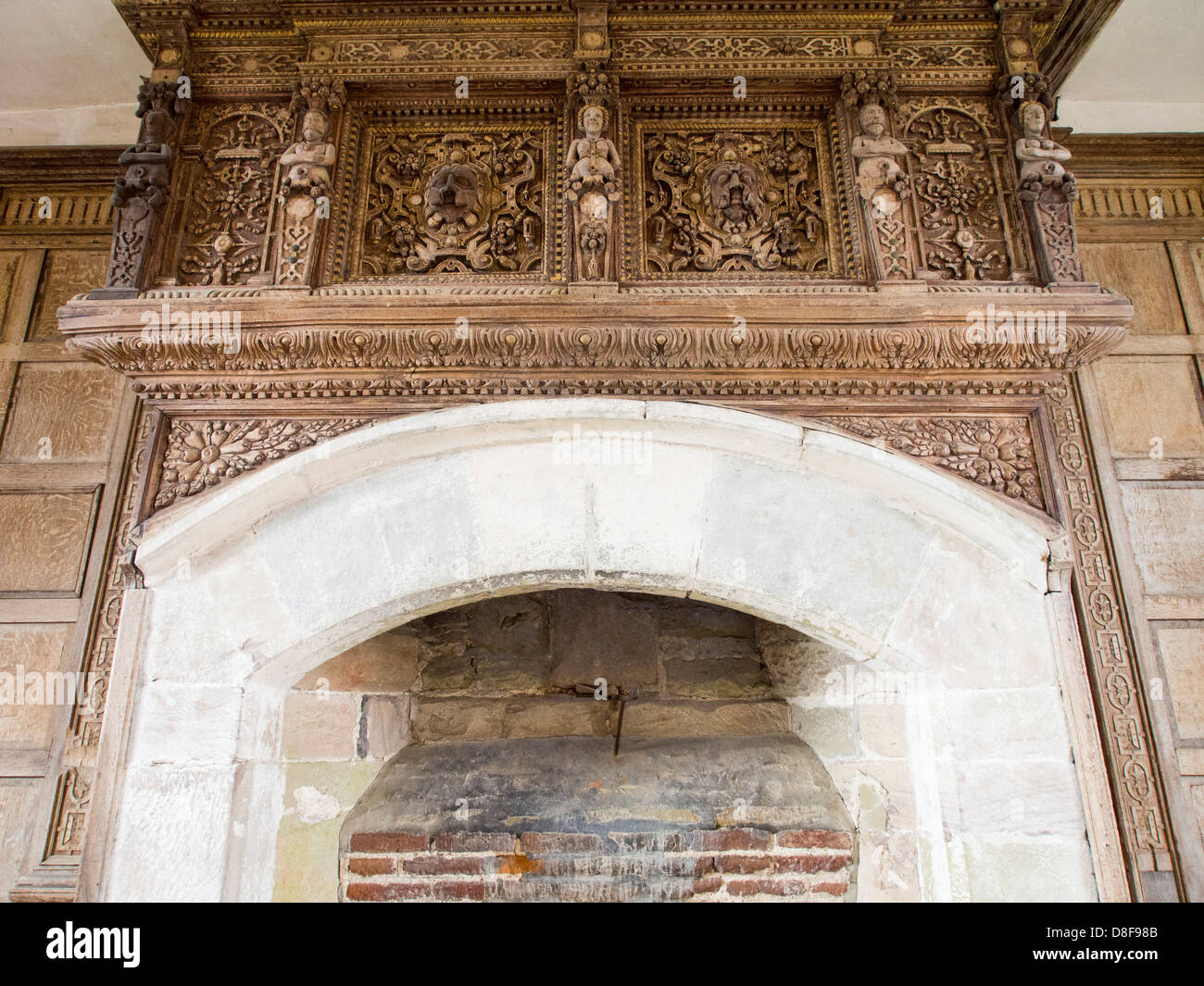 Intricate wood carving above the fire place in Stokesay Castle which is a fortified manor house in Stokesay, Stock Photo