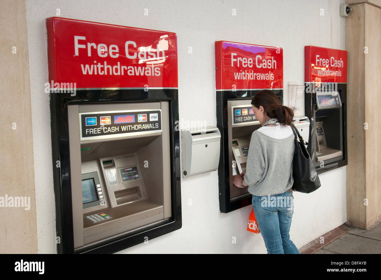 woman at ATM, free cash withdrawals Stock Photo