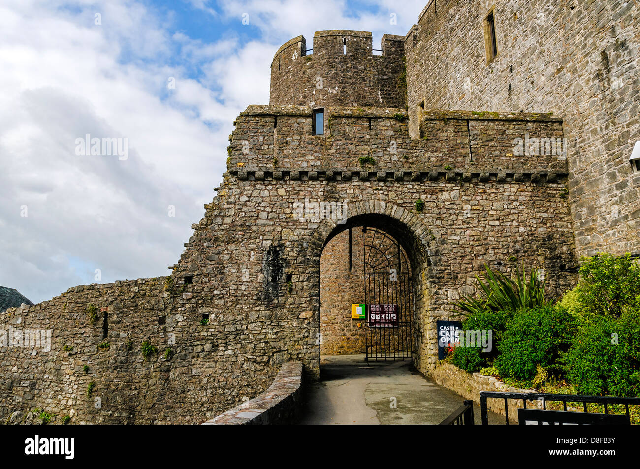 The barbican and one of the two round towers of the gatehouse defending the entrance into the outer ward of Pembroke Castle Stock Photo