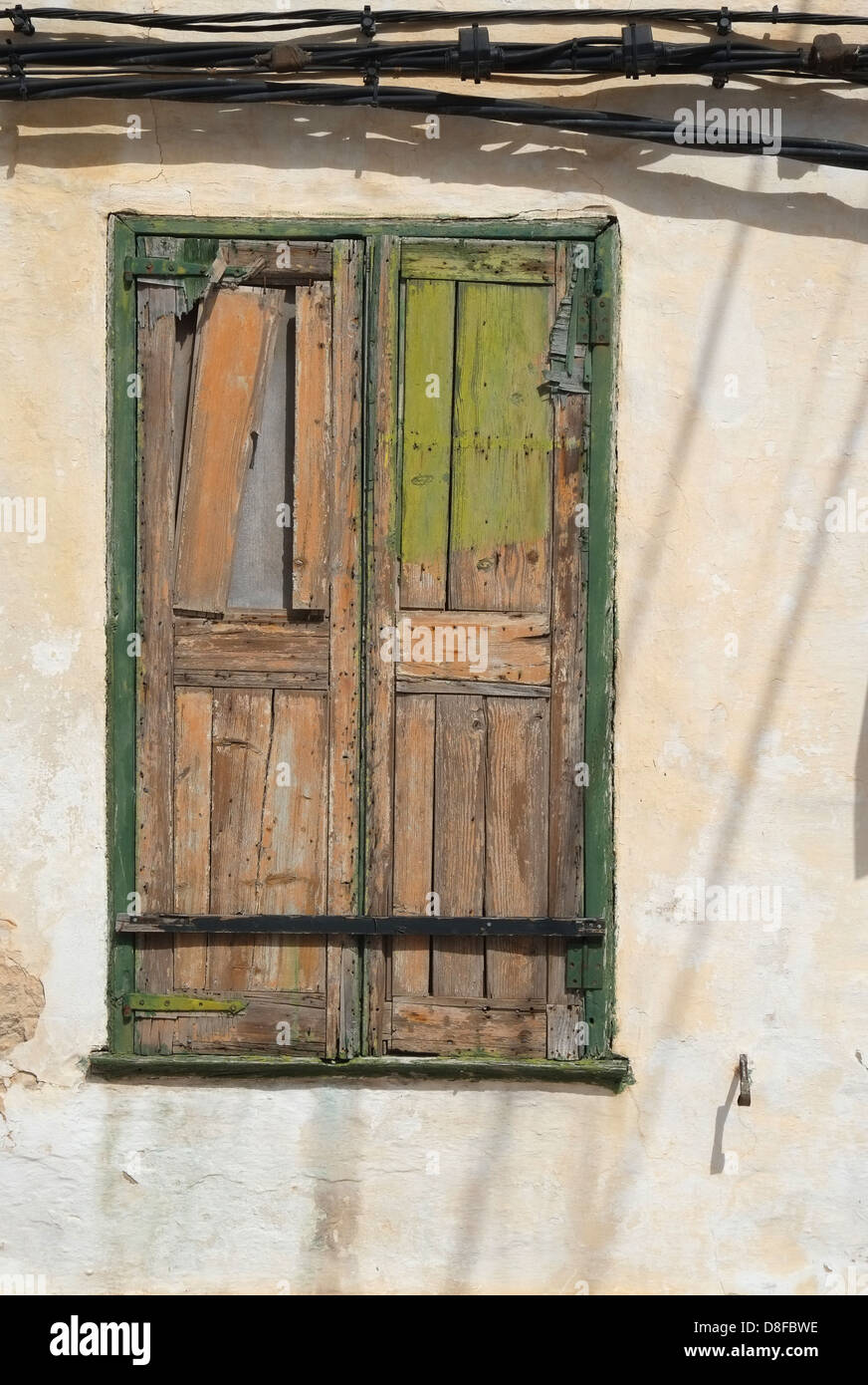 Weatherbeaten wooden window shutter, Menorca, Spain Stock Photo