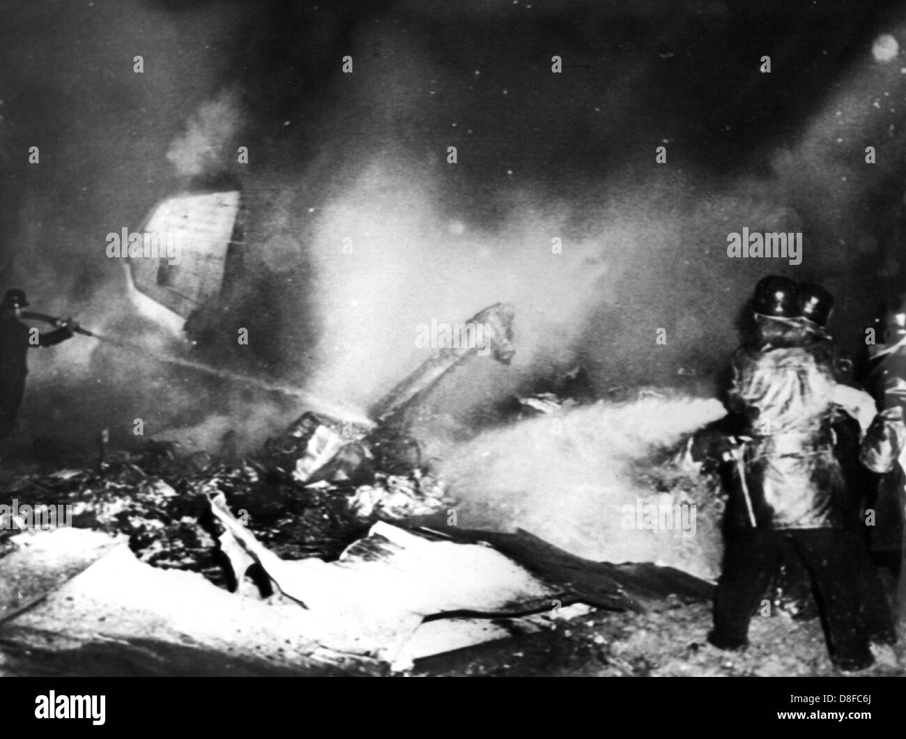 Rescue team at the burning wreck of a Lufthansa machine, that crashed near the airport of Bremen on the 28th of January in 1966. The crew and passengers did not survive. Stock Photo