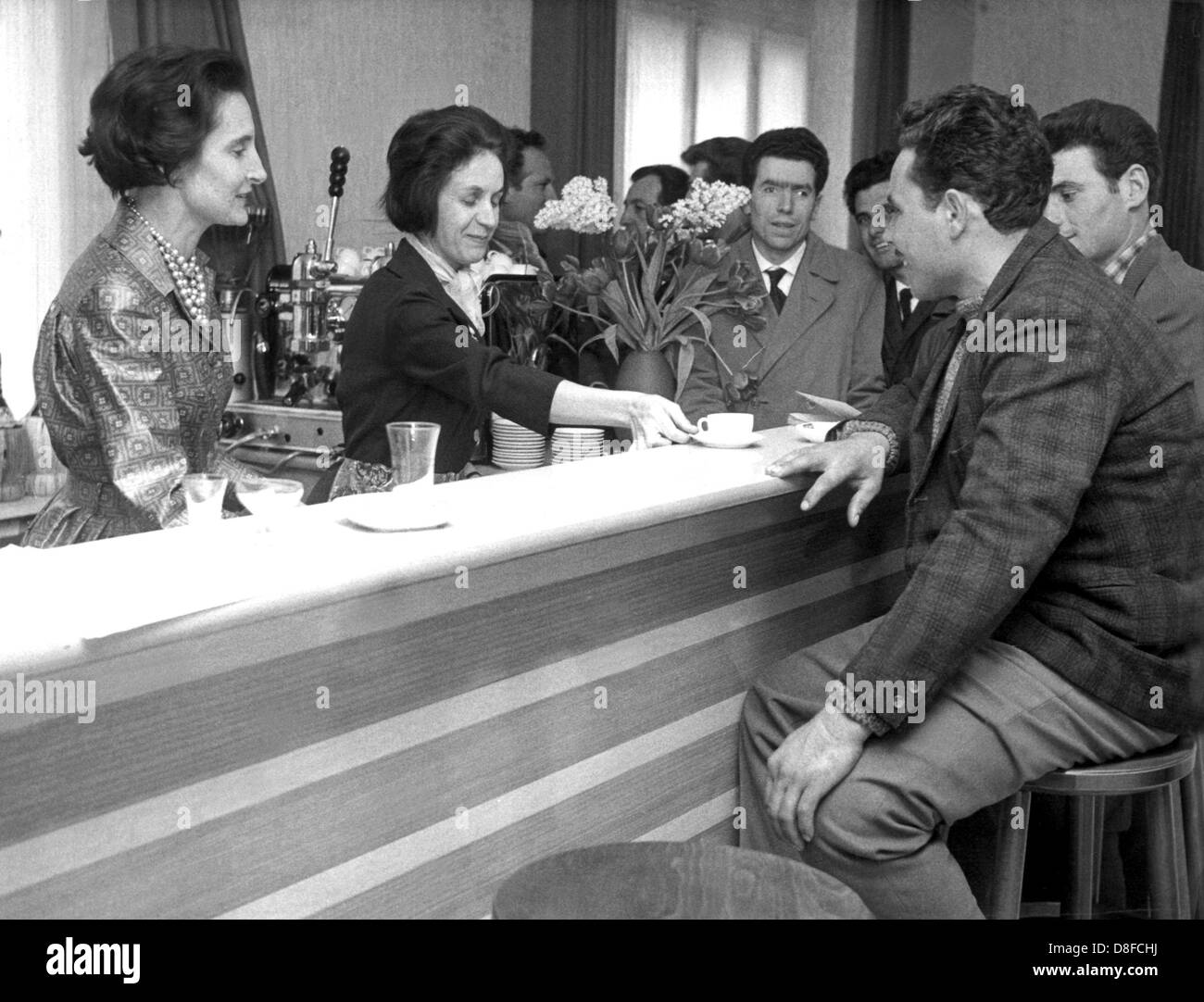 Italian Gastarbeiter (especially guest workers in Germany in the 1960s and 1970s) sit at the bar of the Centro Italiano. The club house for the round 10,000 guest workers in the Rhine-Main area was opened on the 23rd of February in 1962. Stock Photo