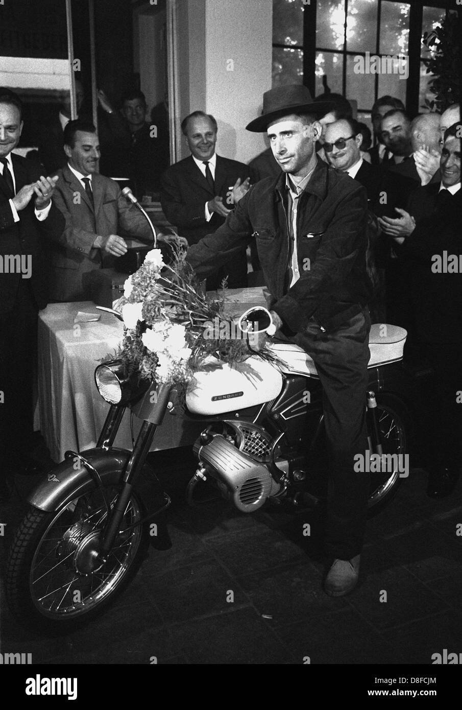 The millionth Gastarbeiter, Armado Rodrigues from Portugal, arrives in the Federal Republic of Germany and receives a moped as a present in Cologne. Stock Photo
