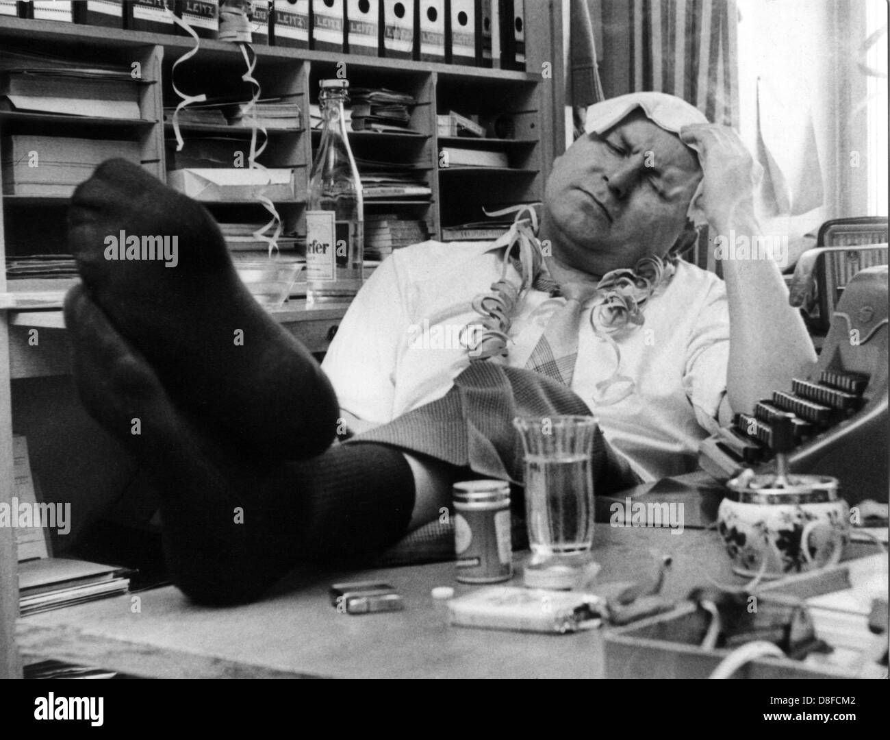 The hangover on Ash Wednesday reminds on the bygone days. Posed picture from 1961. Stock Photo