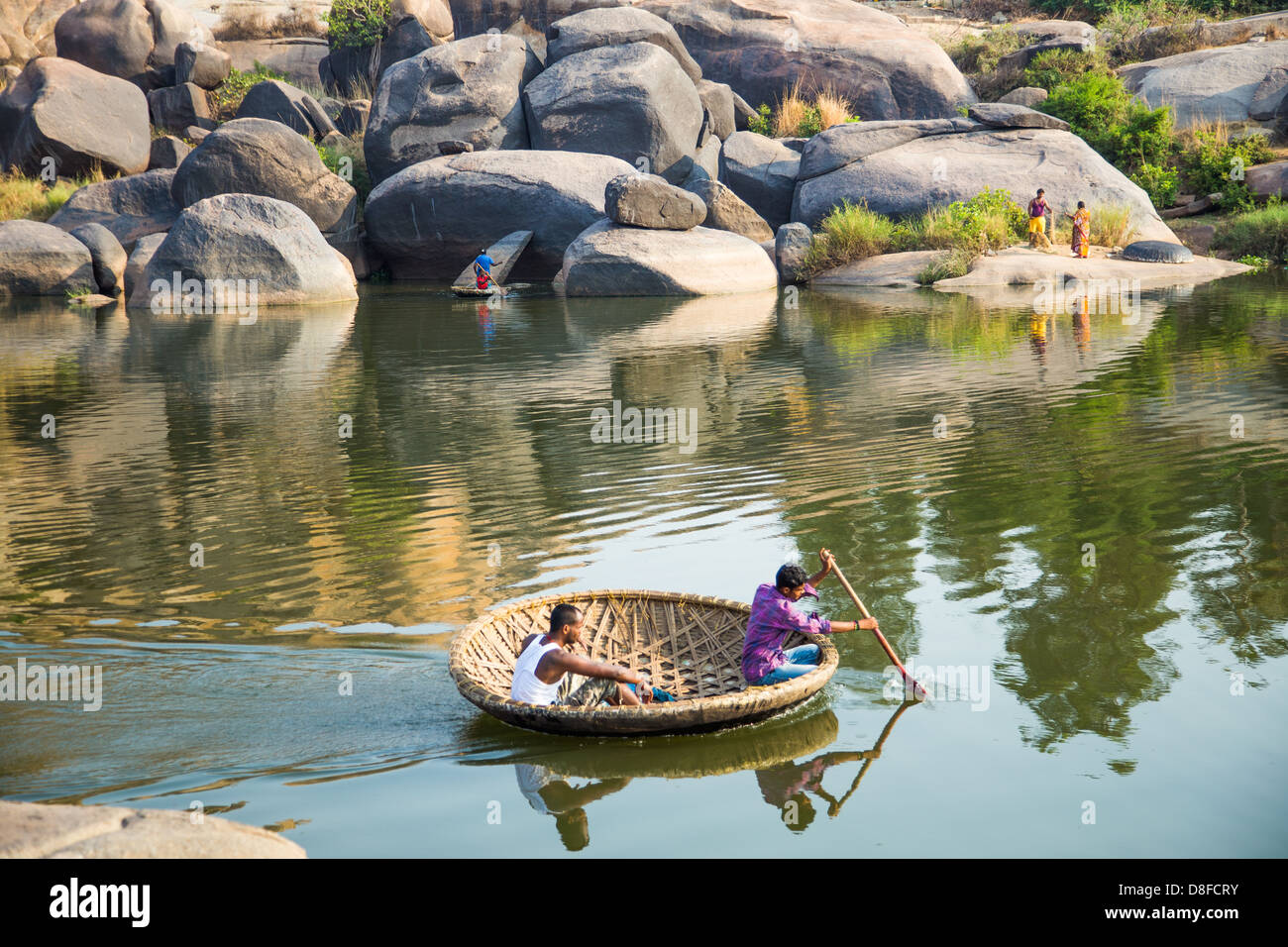 Traditional coracle boat on the Tungabhadra river in Hampi, India Stock Photo