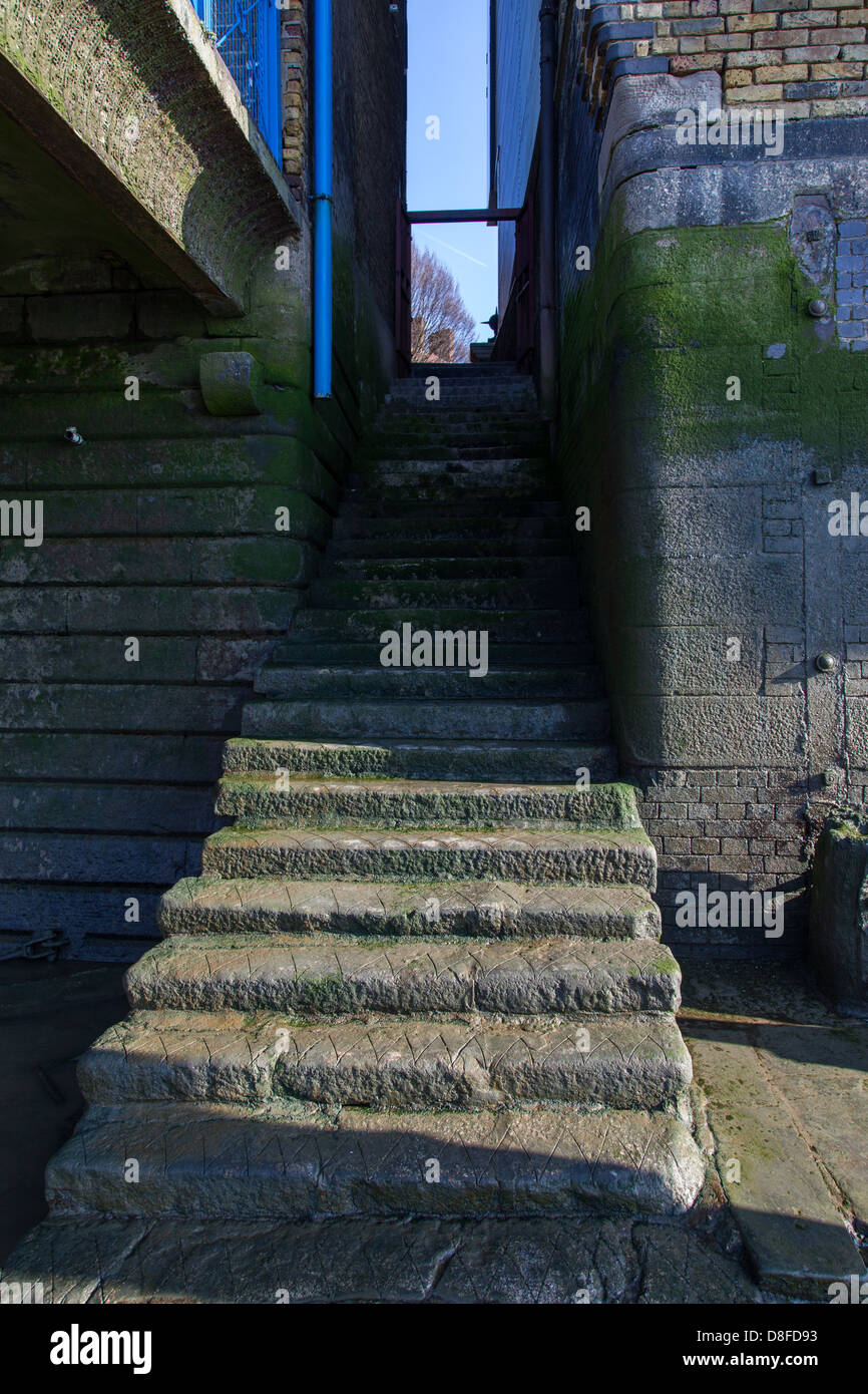 Old stairs down to river Thames foreshore, Wapping, London Stock Photo
