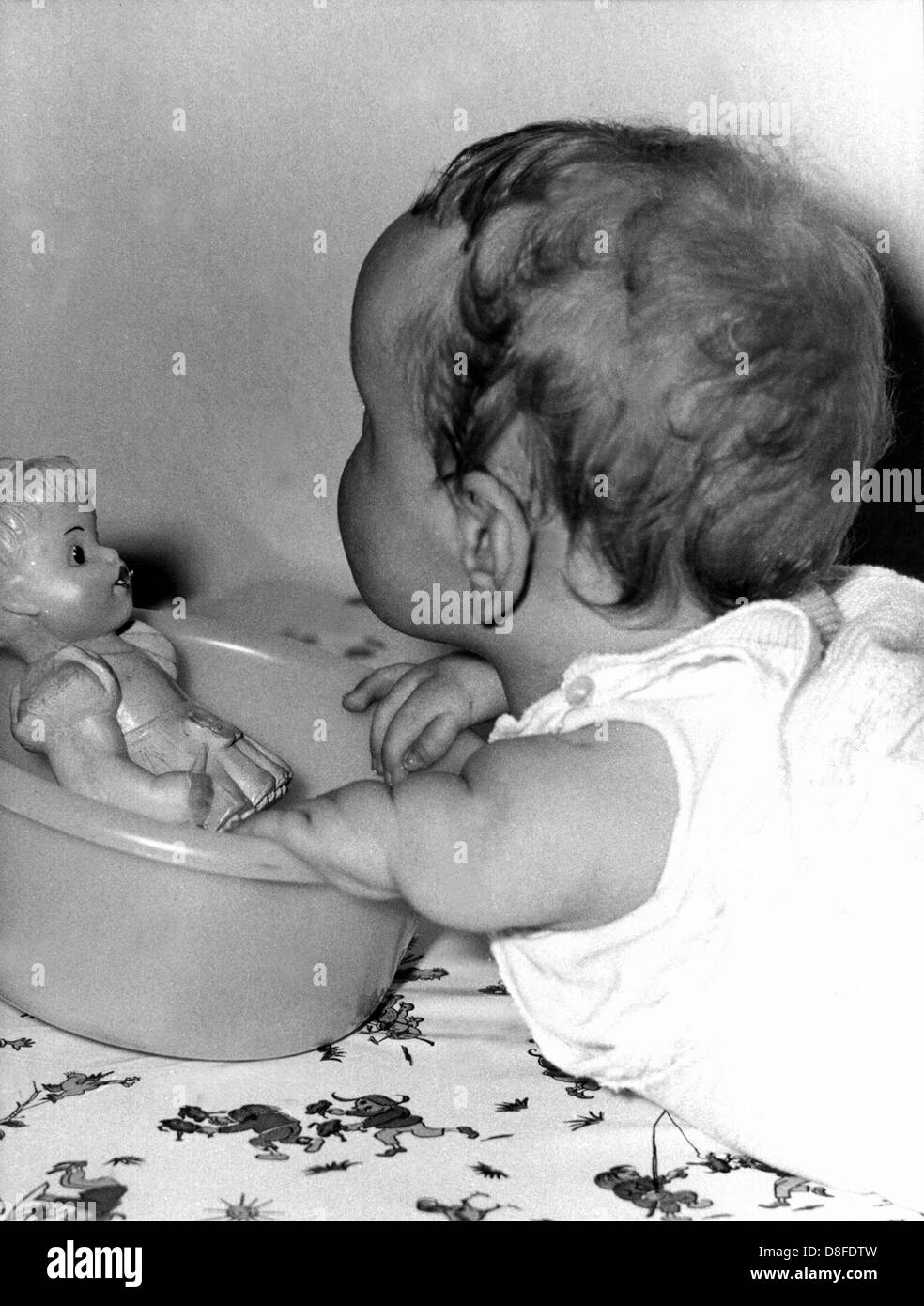 A handicapped child plays with a doll in the 'Anna-Stift' hospital in Hanover, Germany. In the late 1950s and 60s about 8,000 to 12,000 children were born with serious deformities, many died, due to the use of the sleeping drug Contergan by their mothers during pregnancy. Drugs containing thalidomide, Contergan among them, were distributed starting 1 October 1957 by Stollberg (located near Aachen, Germany) based pharmaceuticals company Grünenthal without proper testing and without barring the drug's use during pregnancy. Reports of serious damages to people's health were ignored until a newspa Stock Photo