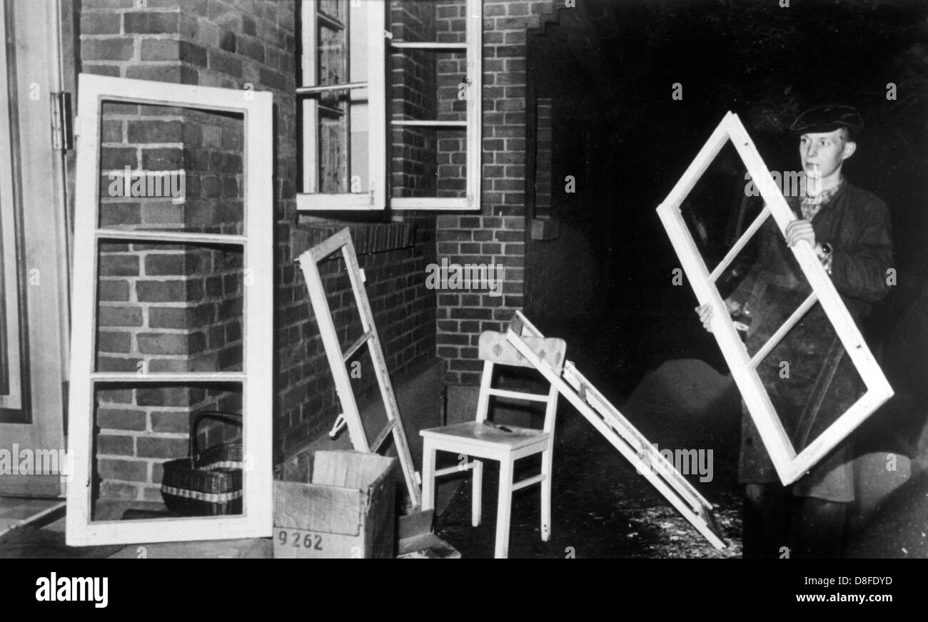A worker replacing burst windows in the house of the village police man ...