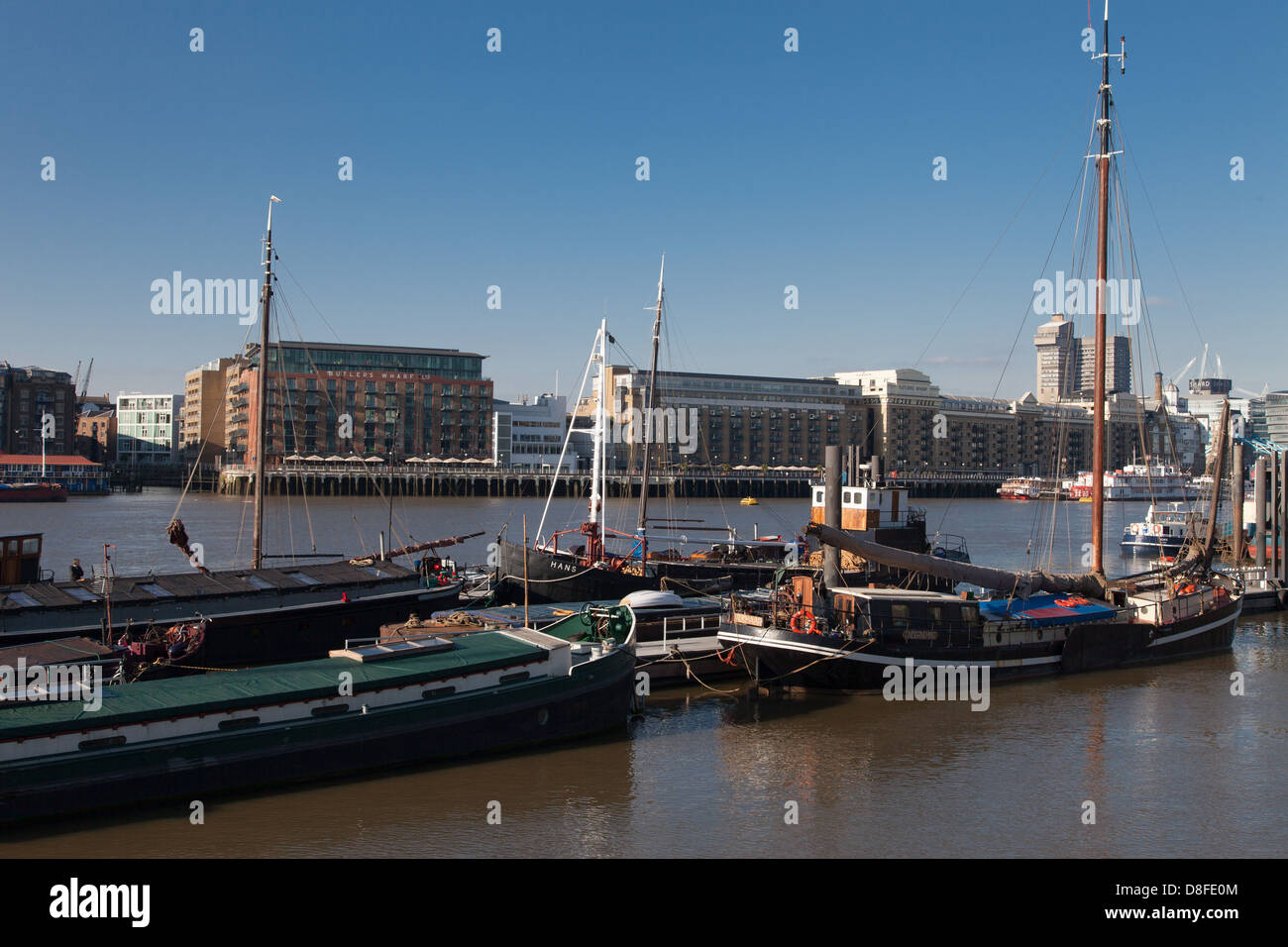 Barges moored on river Thames at Hermitage moorings, Wapping, London Stock Photo