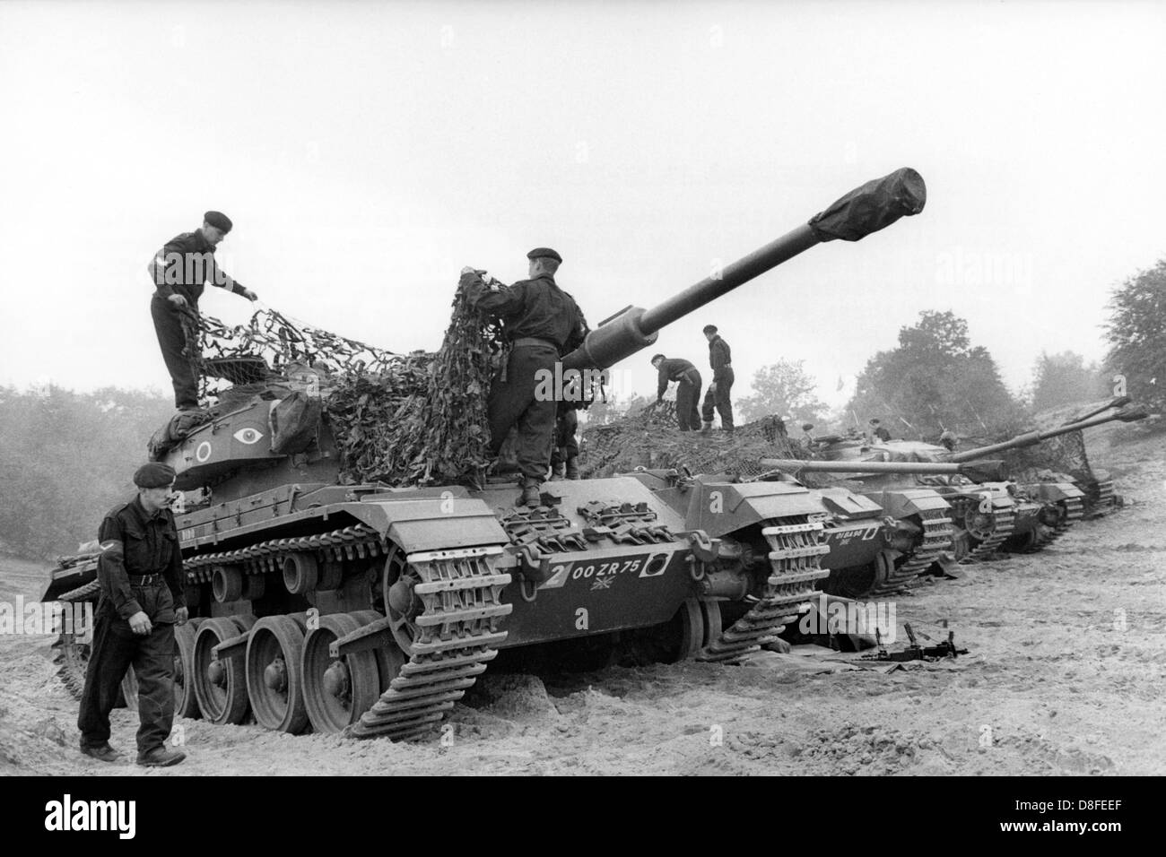 Centurion tanks of the British army are camouflaged within the frame of an allied tank exercise