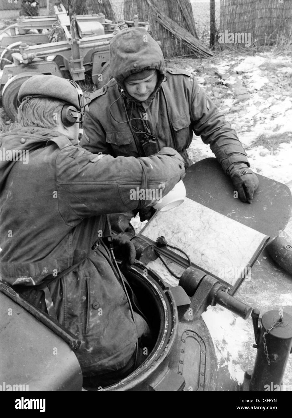 German tank soldiers study maps during their coffee break on the 10th of January in 1966. The soldiers and the tank are part of the German-American manoeuvre 'Silberkralle', in which 22,000 soldiers of the 3rd US tank division and 3,000 German soldiers of the 15th tank brigade Koblenz were involved. Stock Photo