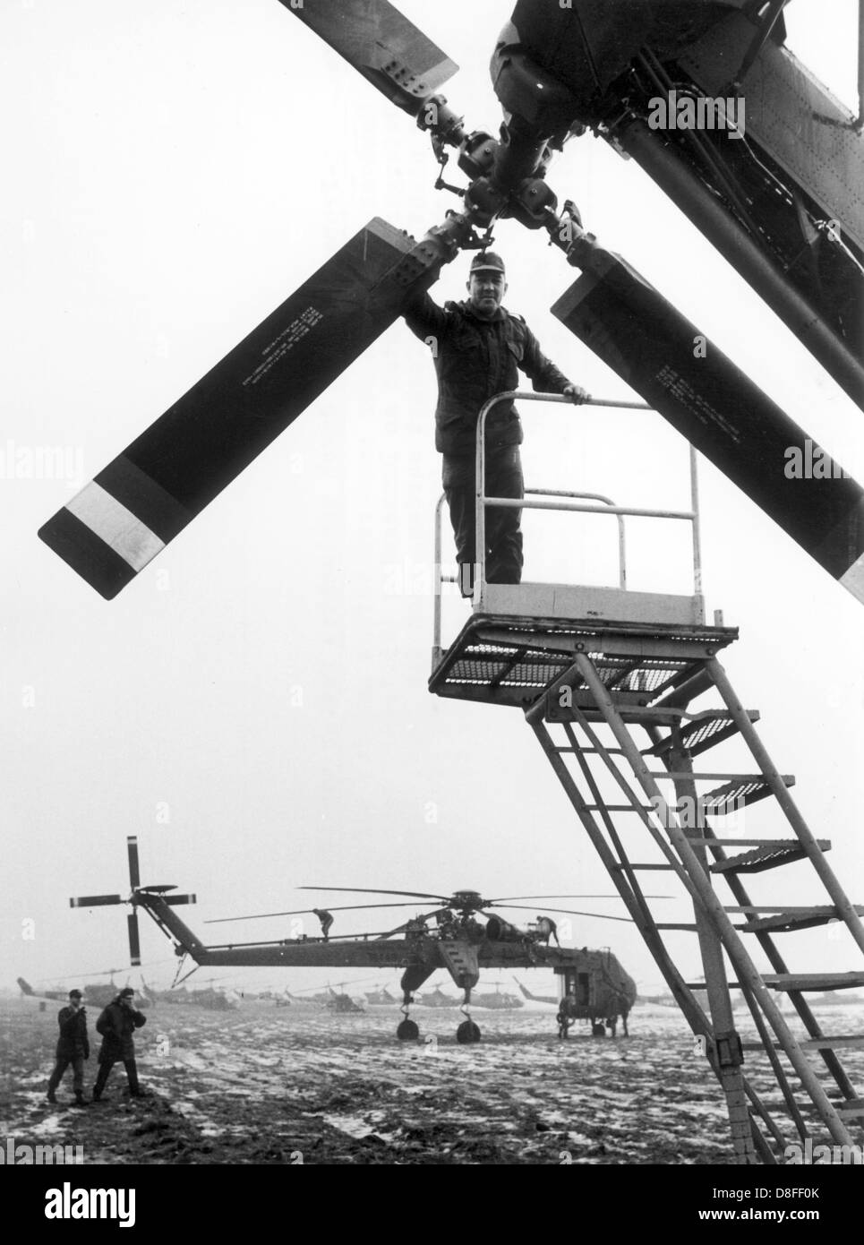 A cargo helicopter of the type Sikorsky CH-54 Tarhe of the US army on a field near Nuremberg on 23 January 1969. Because of the bad weather the helicopters, of which the name 'Tarhe' refers to a chief of the Wyandot Indians whose nickname was 'the crane', had to stay down. The machines were in operation for the manoeuvre 'REFORGER I' - 'Return of Forces to Germany'. Altogether about 17.000 soldiers participated in the manoeuvre, many of them were brought from the USA to Germany via air bridge. The equipment of the soldiers has partially been in depots in Germany already. Stock Photo