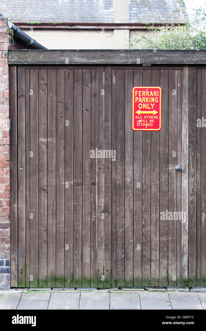 Humorous sign on a garage door Stock Photo - Alamy