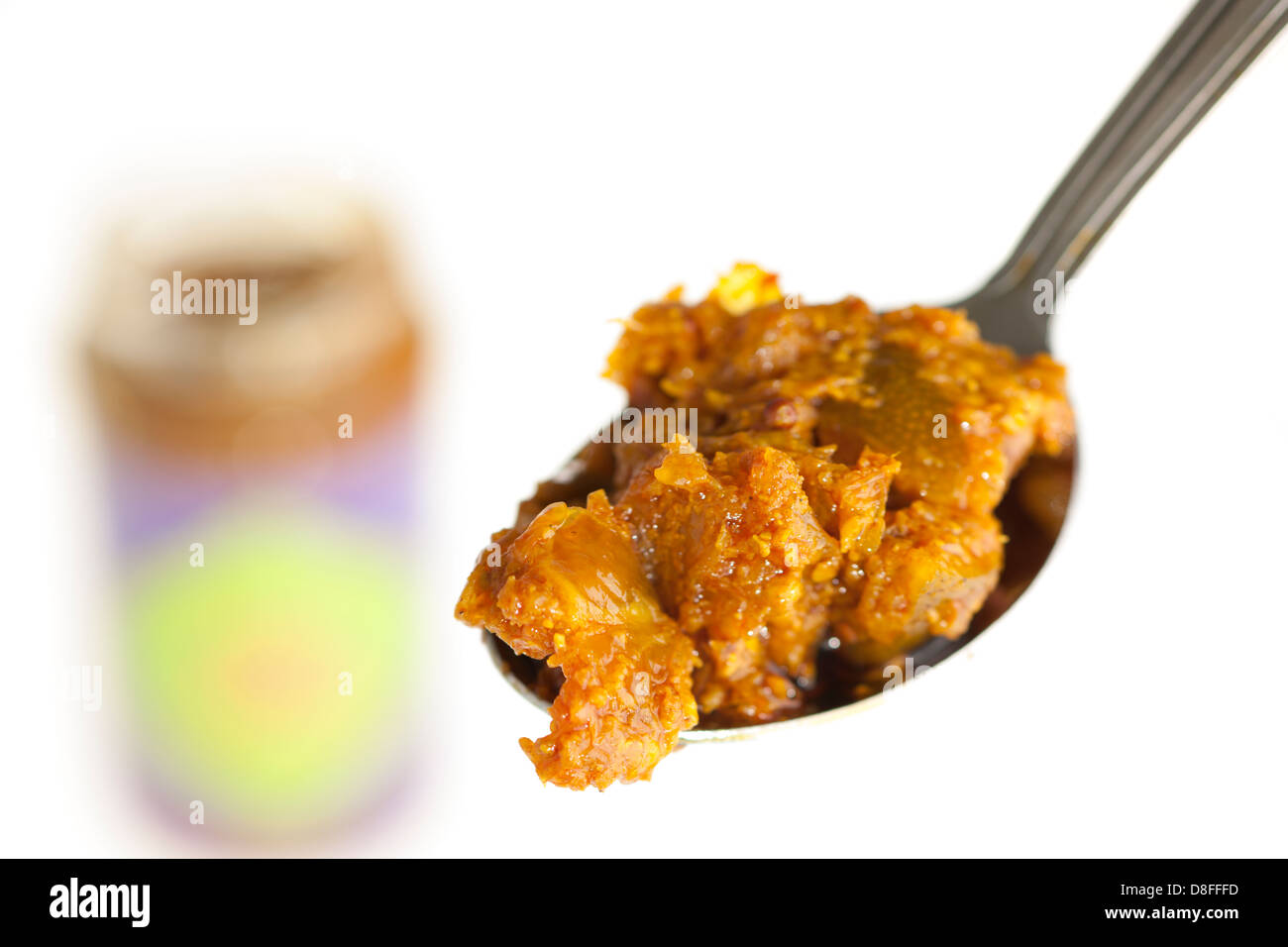 Jar and spoonful of lime pickle Stock Photo
