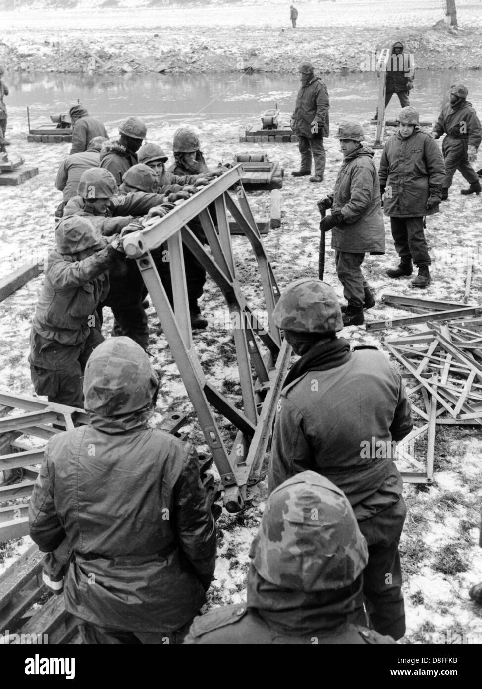 Pioneers of the US army build a bridge across the river Tauber on the 10th of January in 1966. The pioneers participated in the German-American manoeuvre 'Silberkralle', in which 22,000 soldiers of the 3rd US tank division and 3,000 German soldiers of the 15th tank brigade Koblenz were involved. Stock Photo