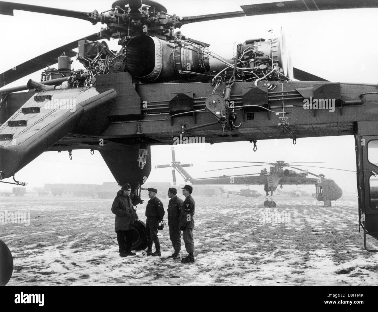 A cargo helicopter of the type Sikorsky CH-54 Tarhe of the US army on a field near Nuremberg on 23 January 1969. Because of the bad weather the helicopters, of which the name 'Tarhe' refers to a chief of the Wyandot Indians whose nickname was 'the crane', had to stay down. The machines were in operation for the manoeuvre 'REFORGER I' - 'Return of Forces to Germany'. Altogether about 17.000 soldiers participated in the manoeuvre, many of them were brought from the USA to Germany via air bridge. The equipment of the soldiers has already been in depots in Germany for the most part. Stock Photo