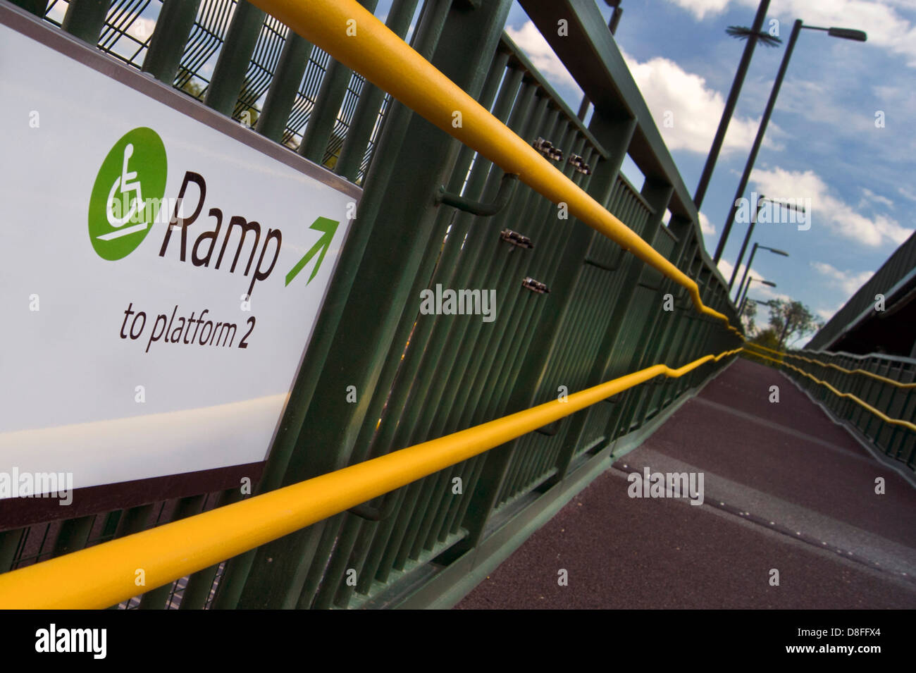Sign showing ramp access to bridge for disabled users at a Stratford-upon-Avon Parkway station. Stock Photo