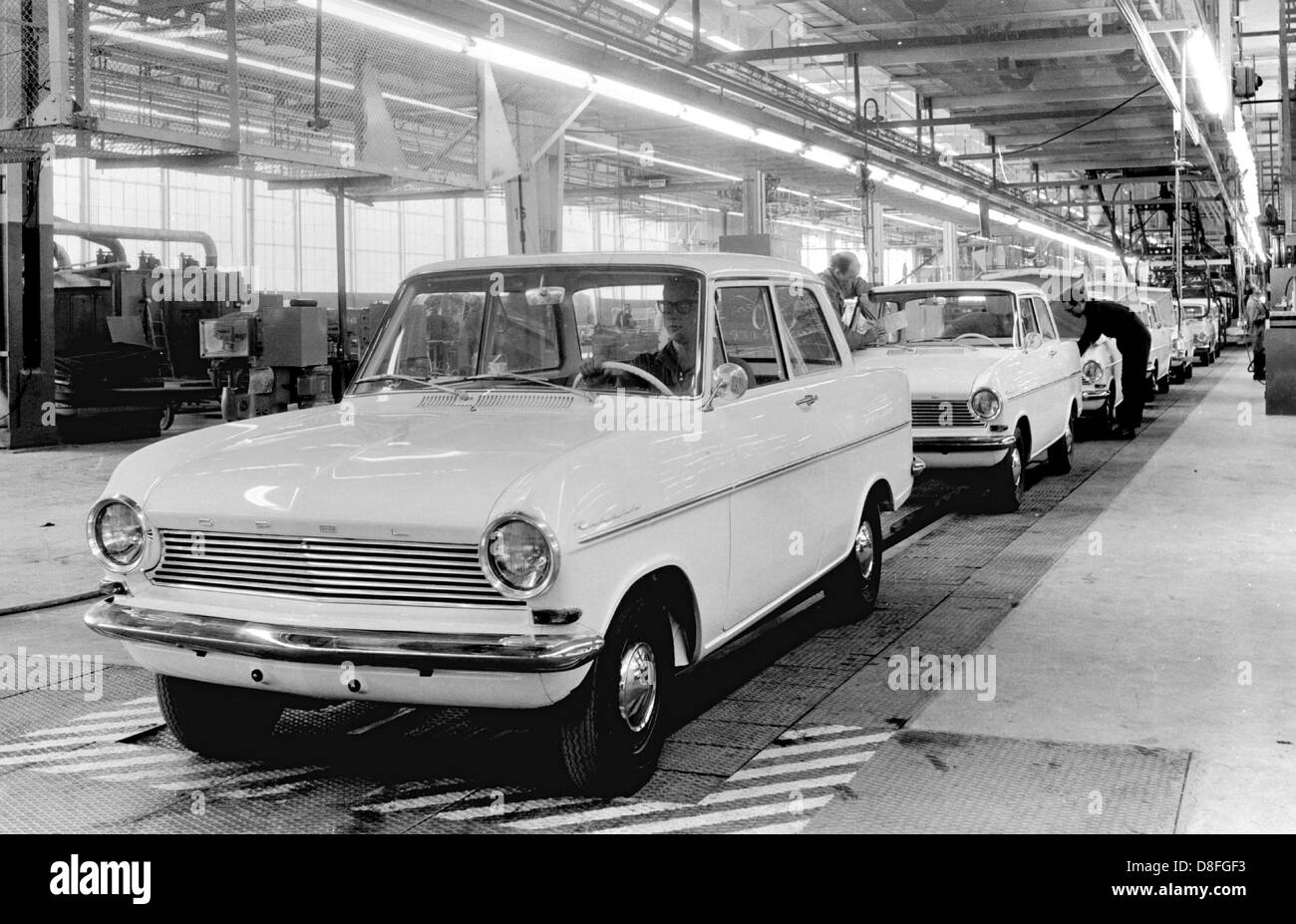 Completed Opel cars of the type Kadett roll off the line in the Opel factory in Ruesselsheim in 1962. Stock Photo