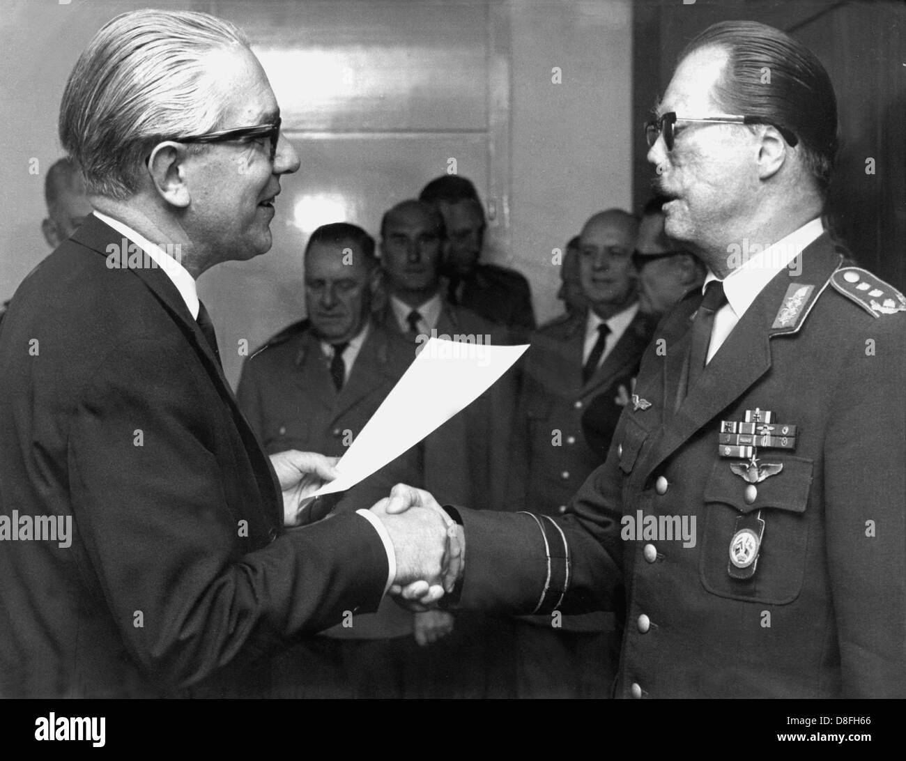 Federal defence minister Kai-Uwe von Hassel (l) hands over the letter of appointment to General Johannes Steinhoff, the new Chief of Staff of the German air force on the 2nd of September in 1966 in Bonn. Stock Photo