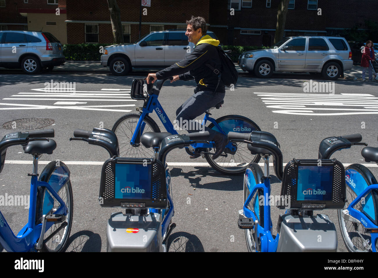 Bicycle enthusiast uses a Citibike in the Chelsea neighborhood of New