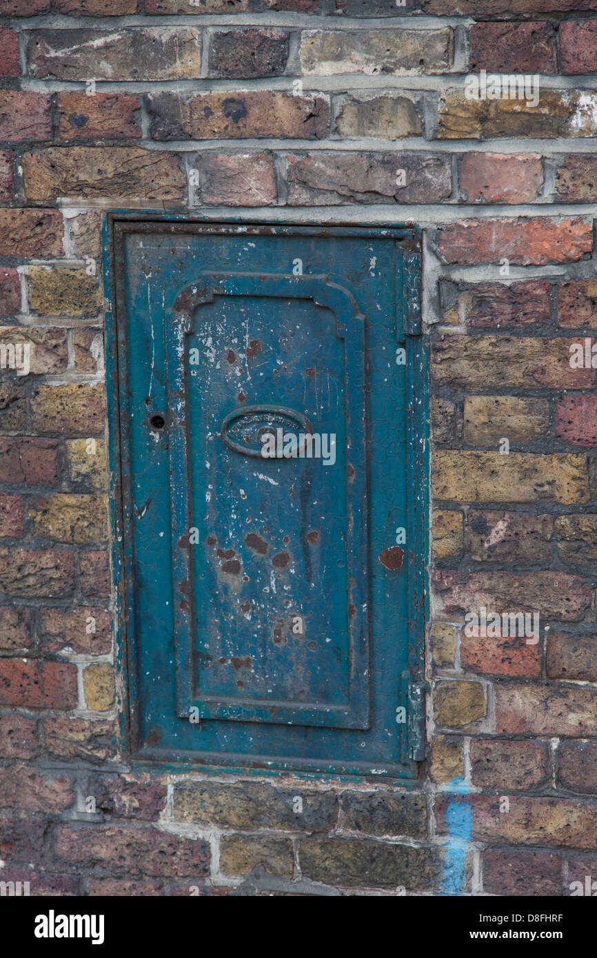 Worn door in exterior wall of St. Katharine's Dock, London Stock Photo