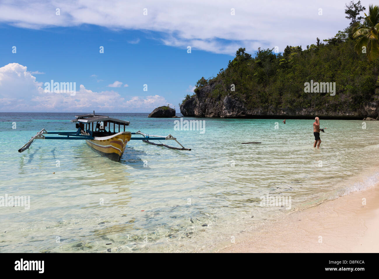 A tourist on an isolated beach in the Togians island in Sulawesi, Indonesia Stock Photo