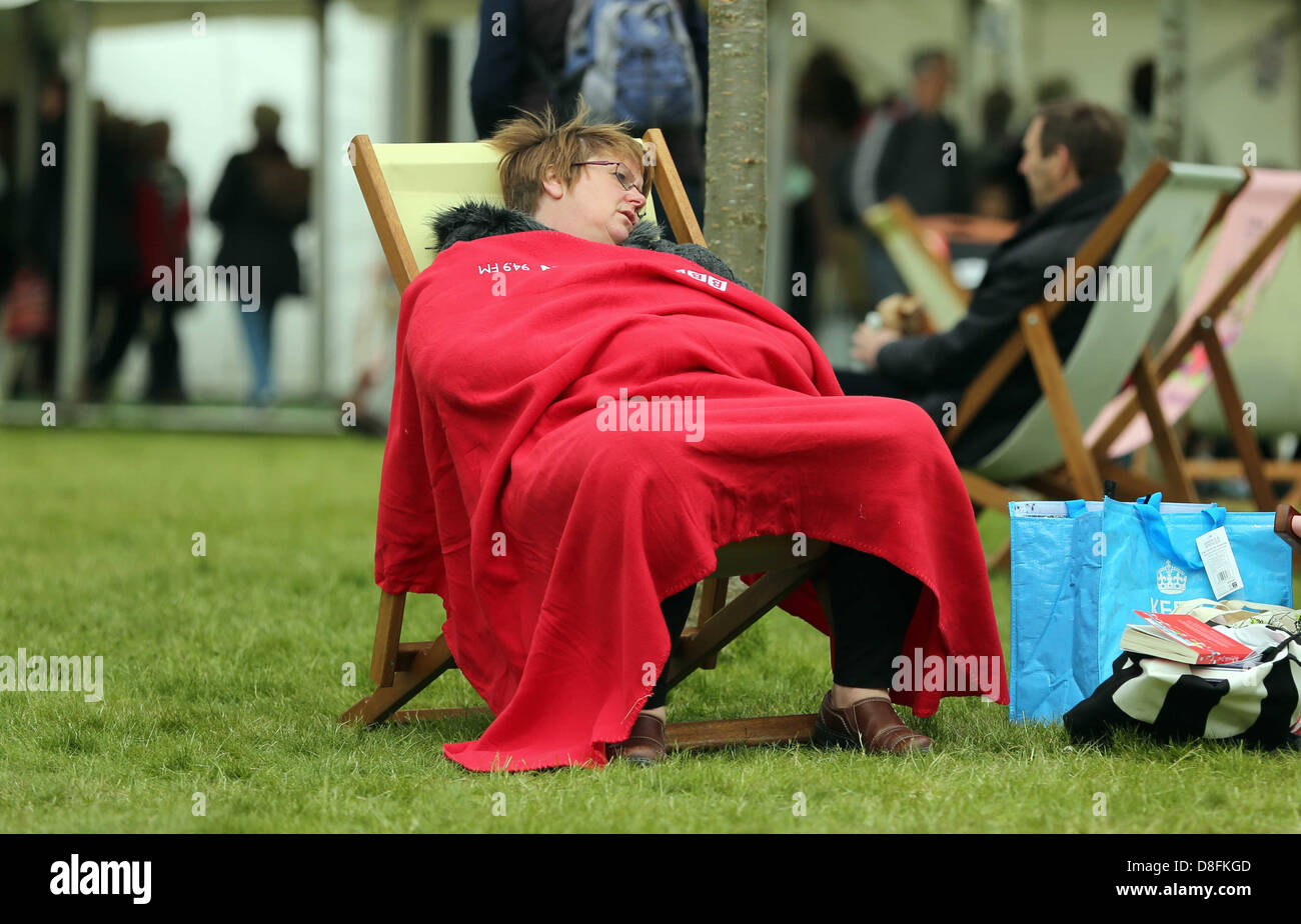 Hay on Wye, UK. 27th May 2013.   Pictured: A woman covers with a blanket because of the coler weather.  Re: The Telegraph Hay Festival, Hay on Wye, Powys, Wales. Credit:  D Legakis / Alamy Live News Stock Photo