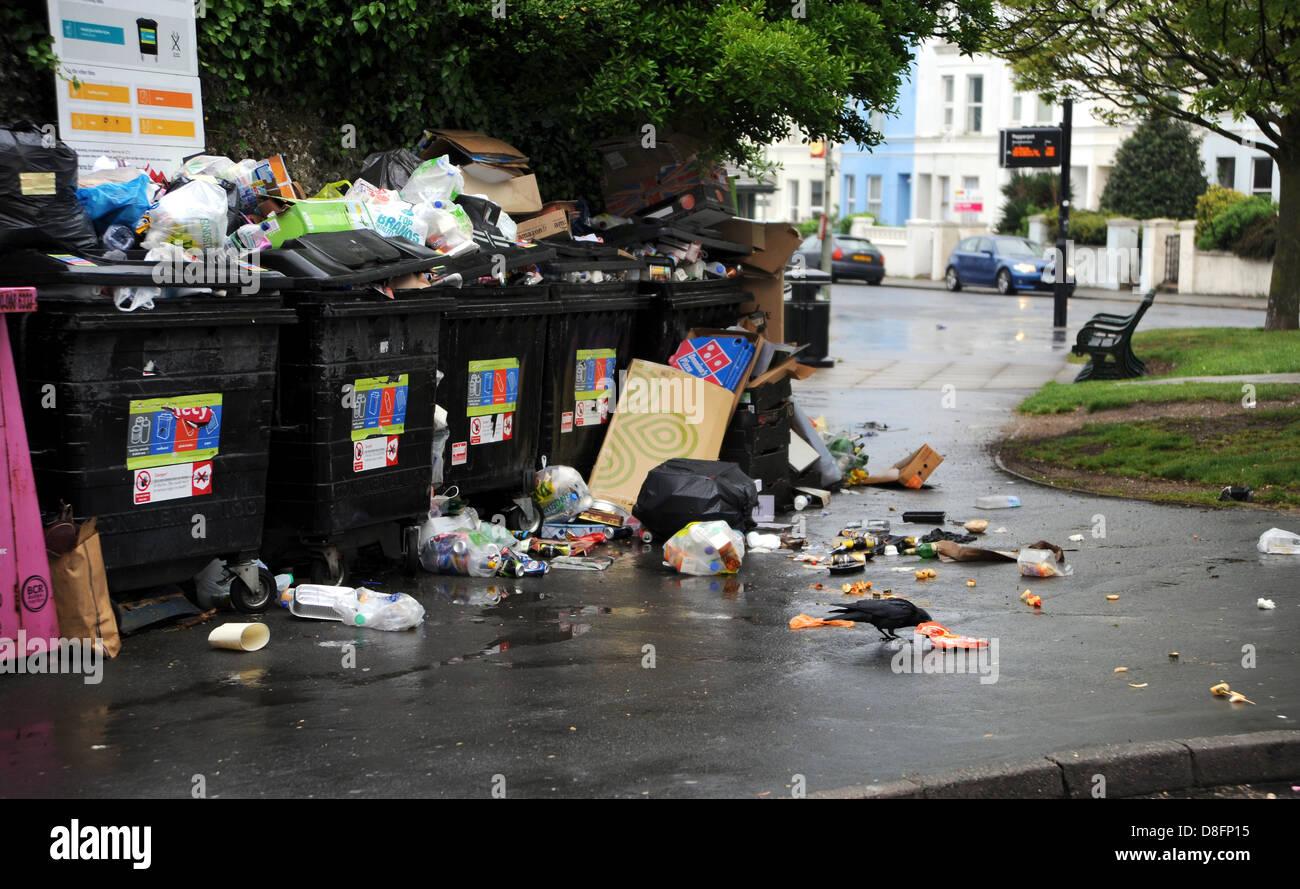 Brighton Sussex UK 28 May 2013 A crow feasts on the overflowing