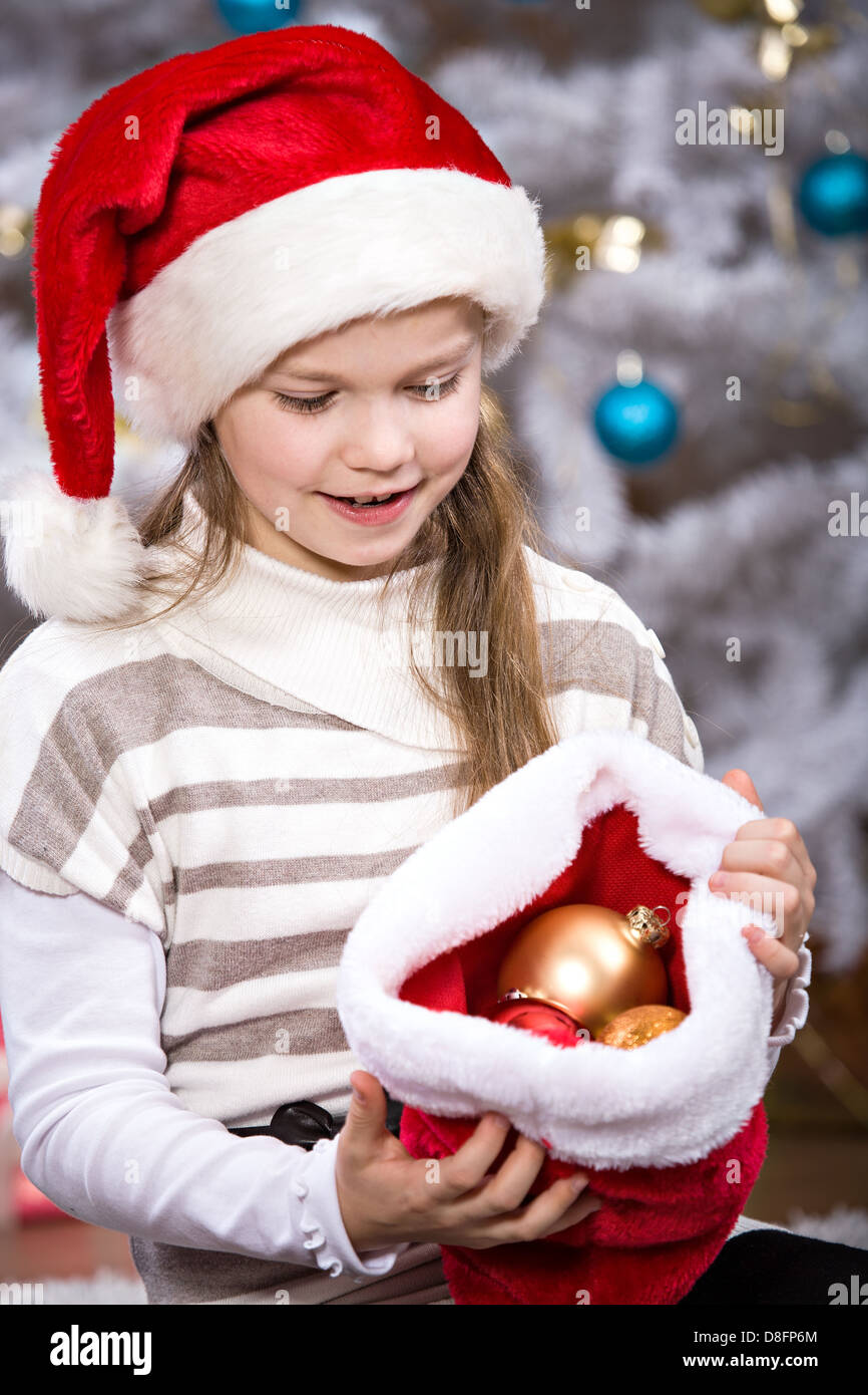 a little girl getting a Christmas Tree decoration Stock Photo Alamy